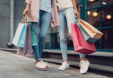 Two female shoppers with bags retail shopping shutterstock_1230910540