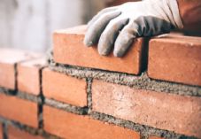 Bogdanhoda close-up-of-industrial-bricklayer-installing-bricks-on-construction-picture-id622800884