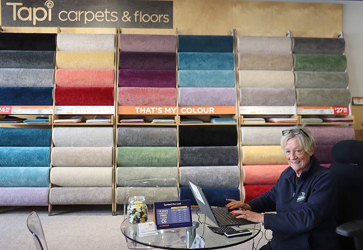 Tapi staff member and carpet display