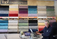 Tapi staff member and carpet display